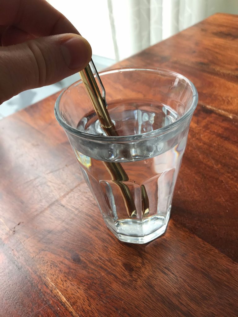 Aqua Aurora Energy Pen in glass of water