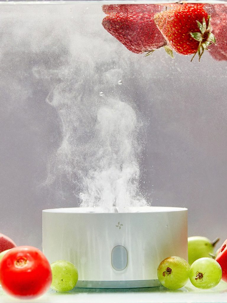 pesticide cleaner in water with tomatoes, grapes and strawberries, bubbles