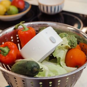 pesticide cleaner in colander with vegetables