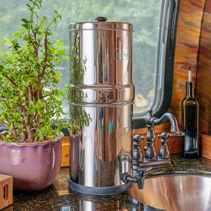 Berkey water filter in motorhome for window near sink, plant on countertop