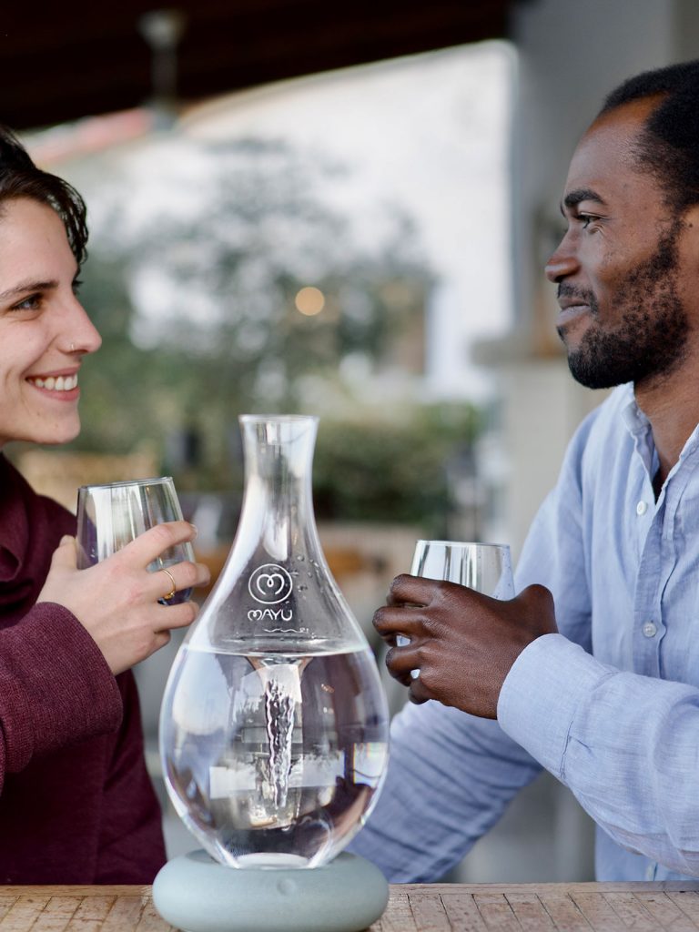 MAYU Swirl, man and woman toast with water