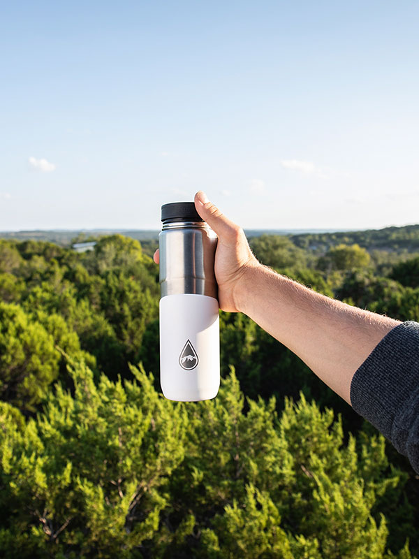 Berkey Stainless steel drinking bottle white in hand for forests